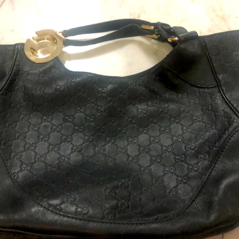 Gucci leather black large authentic bag with super-sized gold “G”s on handle.